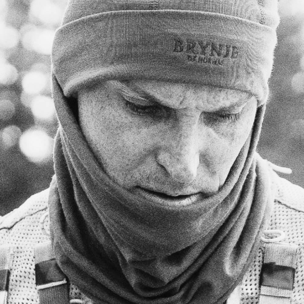 Person wearing a headband with 'Brynje' branding in a black and white photo.